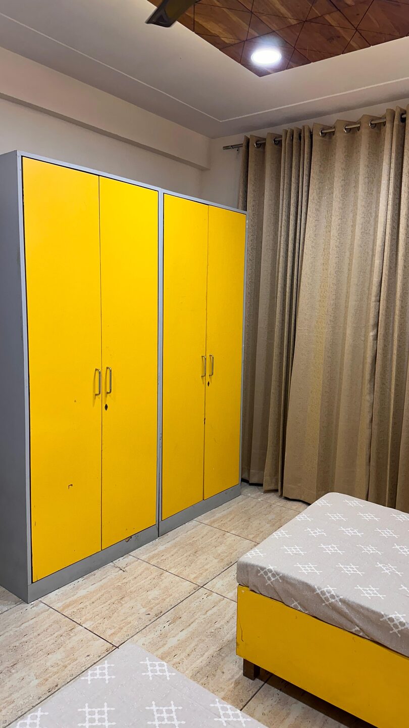 Roomy wardrobe and personal cupboard storage beside the bed